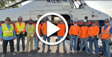 Video thumbnail for a roof top install project showing Hill York team members standing by a helicopter