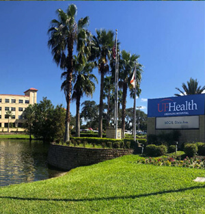 View of the entrance and pond of UF Health's facility in Leesburg, Florida