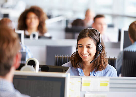 Lady smiling on a headset in a call center